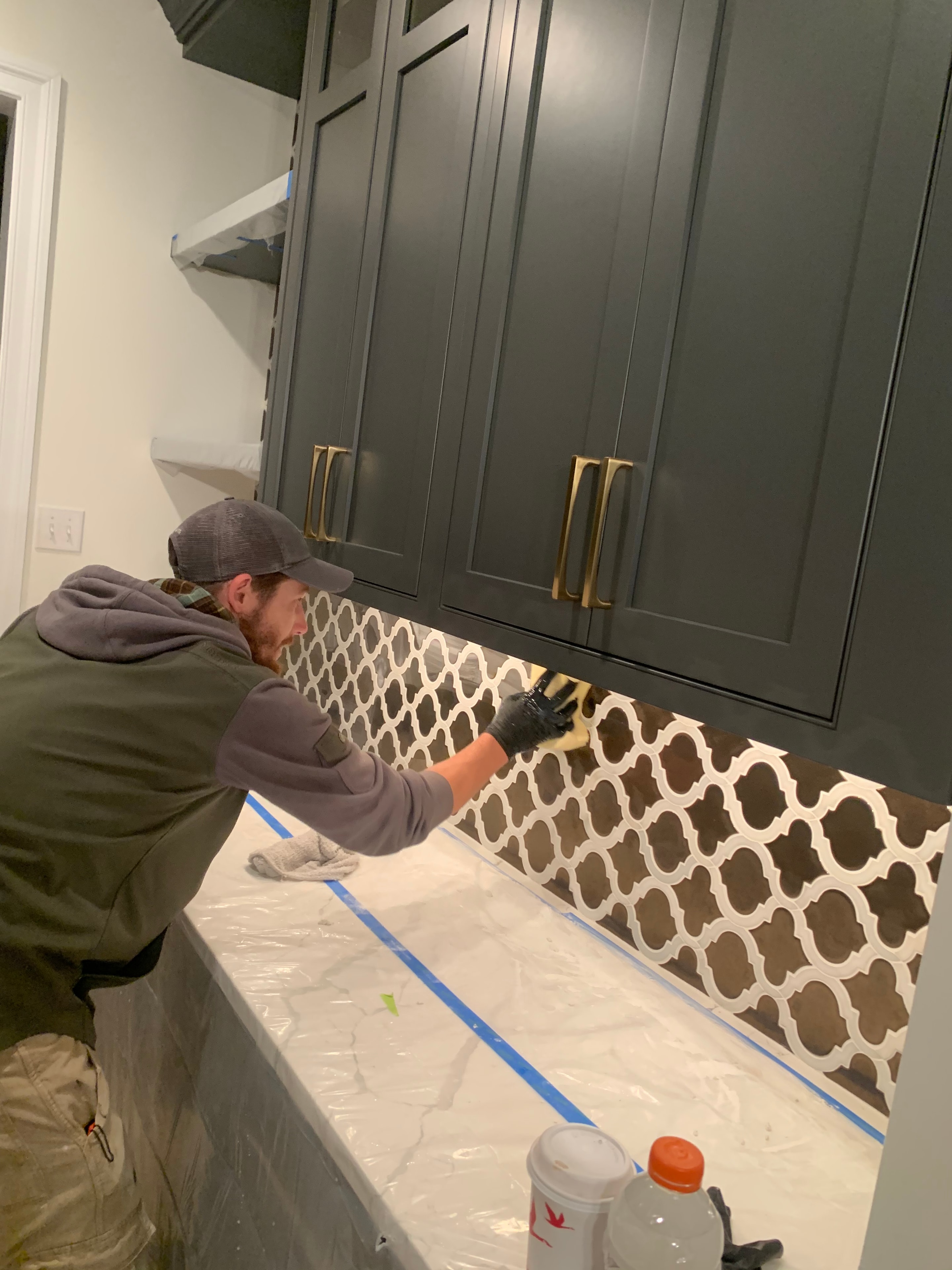 Contractor reviewing tile layout plans on a job site